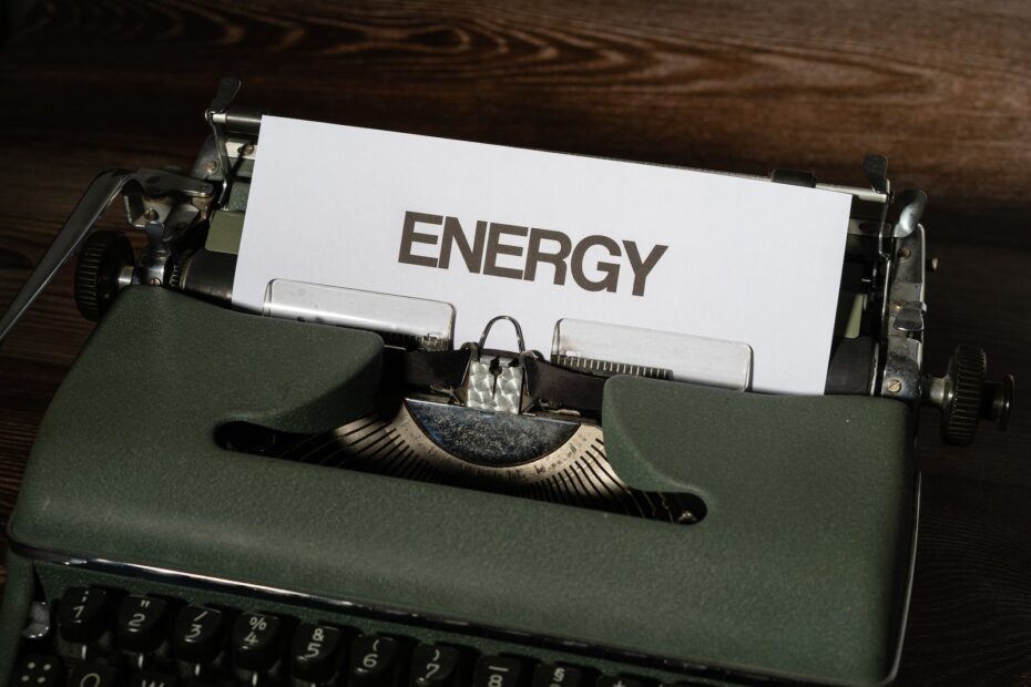 Green and White Typewriter on Brown Wooden Table